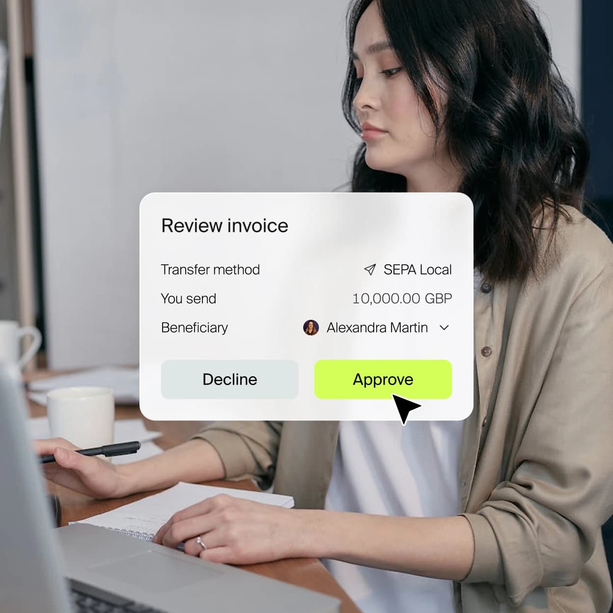 Person at a laptop reviewing an invoice with decline and approve actions